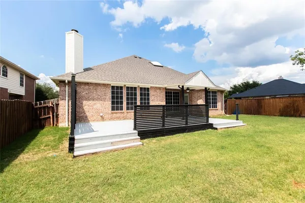 a view of a house with a yard and roof