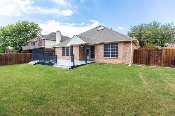 a view of a house with a yard and garden