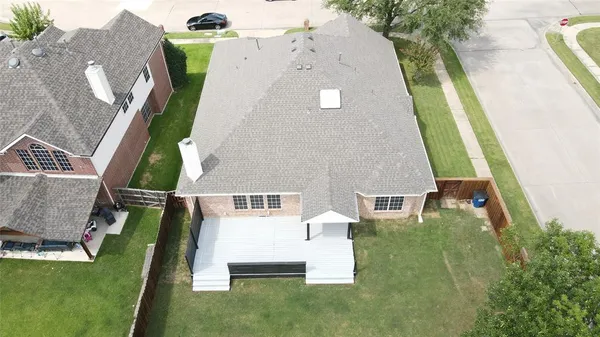 an aerial view of a house with a garden and swimming pool