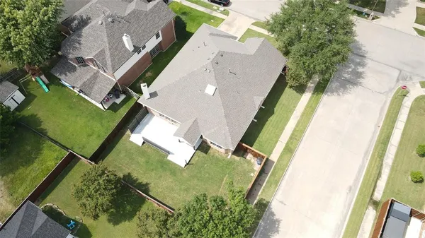 an aerial view of a house with a yard