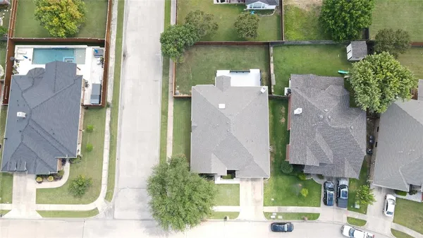 an aerial view of a house with a yard and a fountain