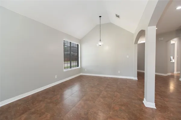 an empty room with fan and windows