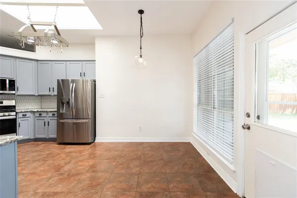 a kitchen with a refrigerator and a sink
