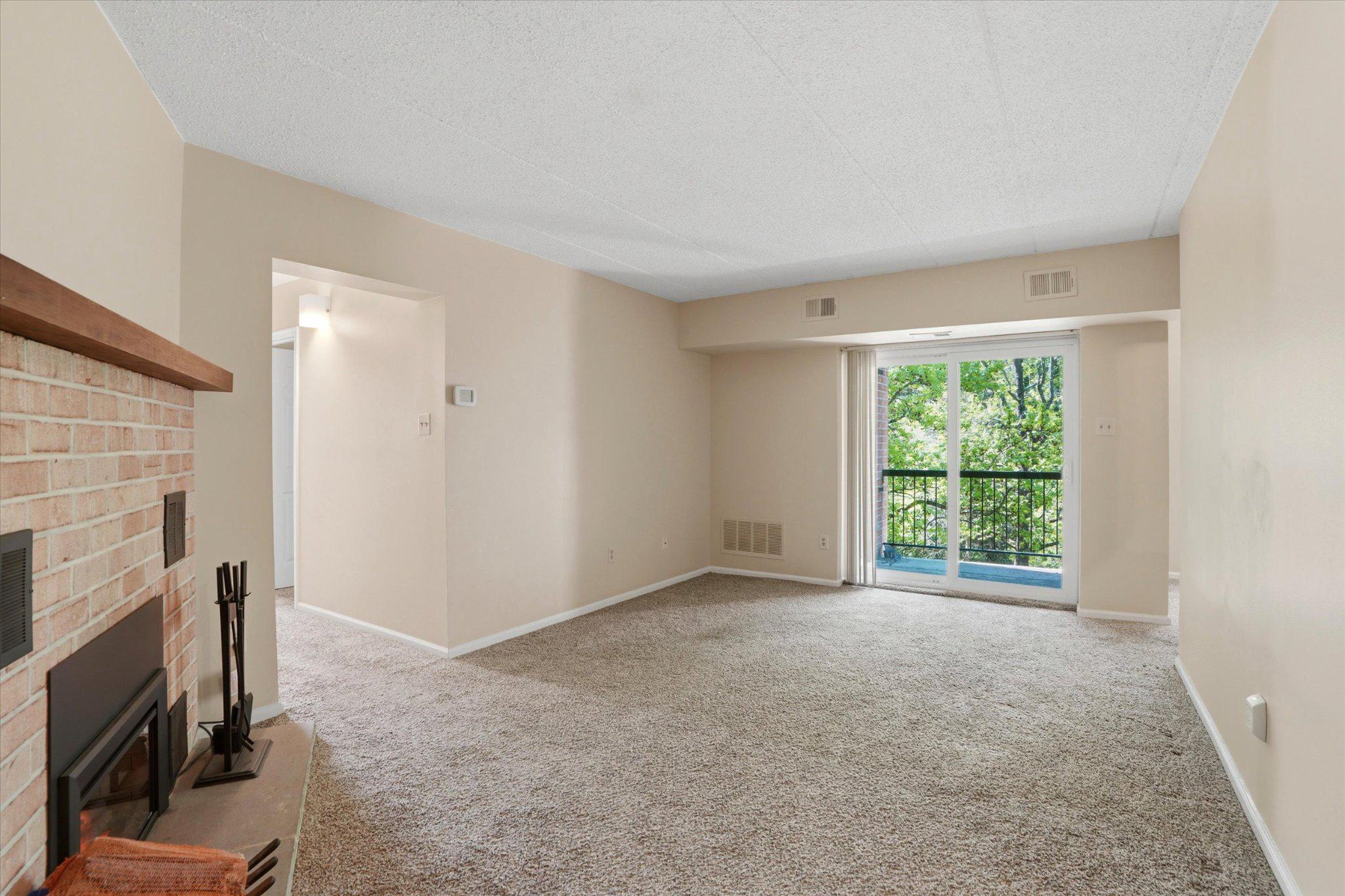 623 Washington Place Chesterbrook, PA 19087 - Photo 12 of 26 a view of an empty room with a fireplace and a window