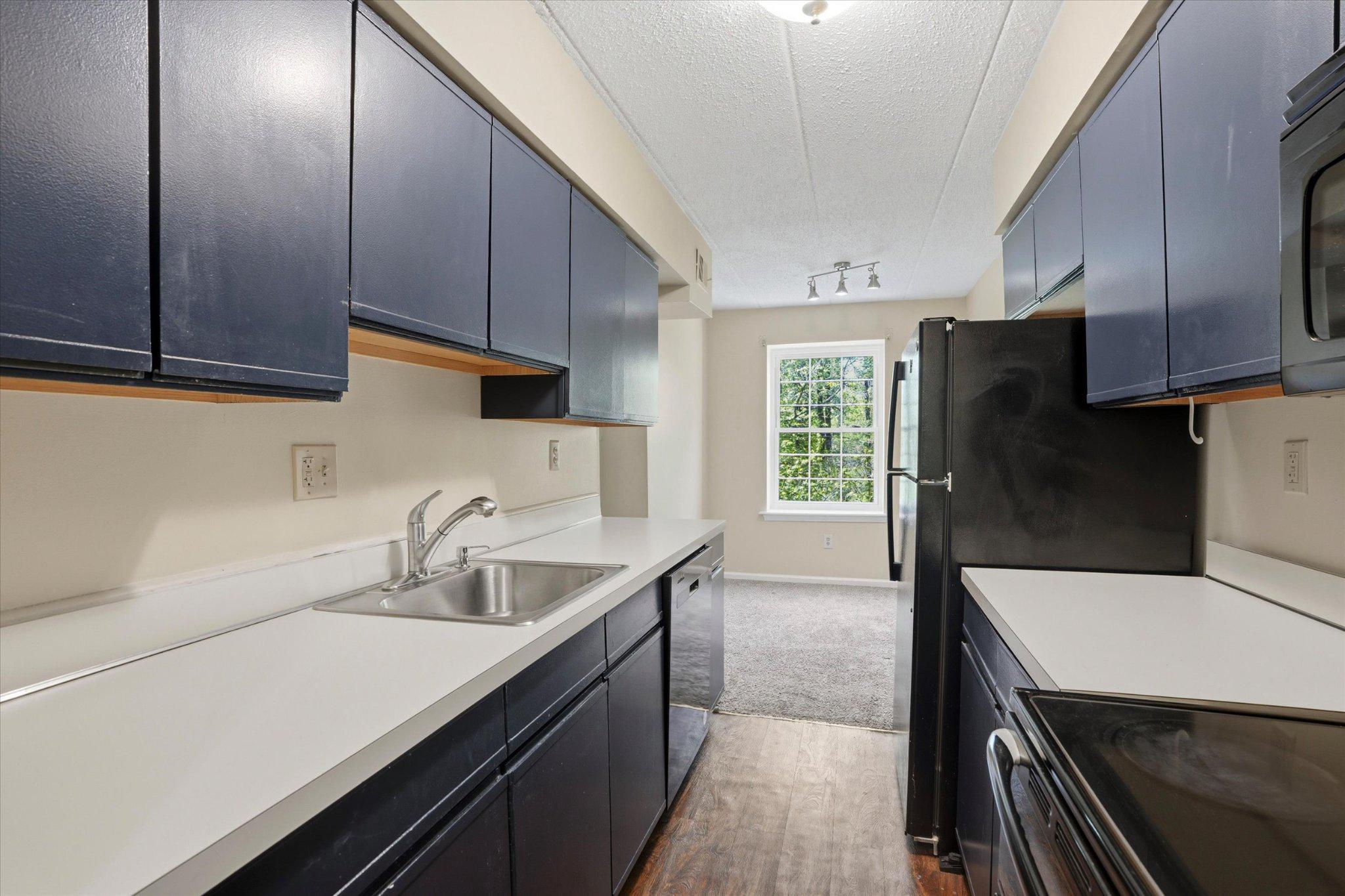 623 Washington Place Chesterbrook, PA 19087 - Photo 5 of 26 a kitchen with a sink a refrigerator and cabinets