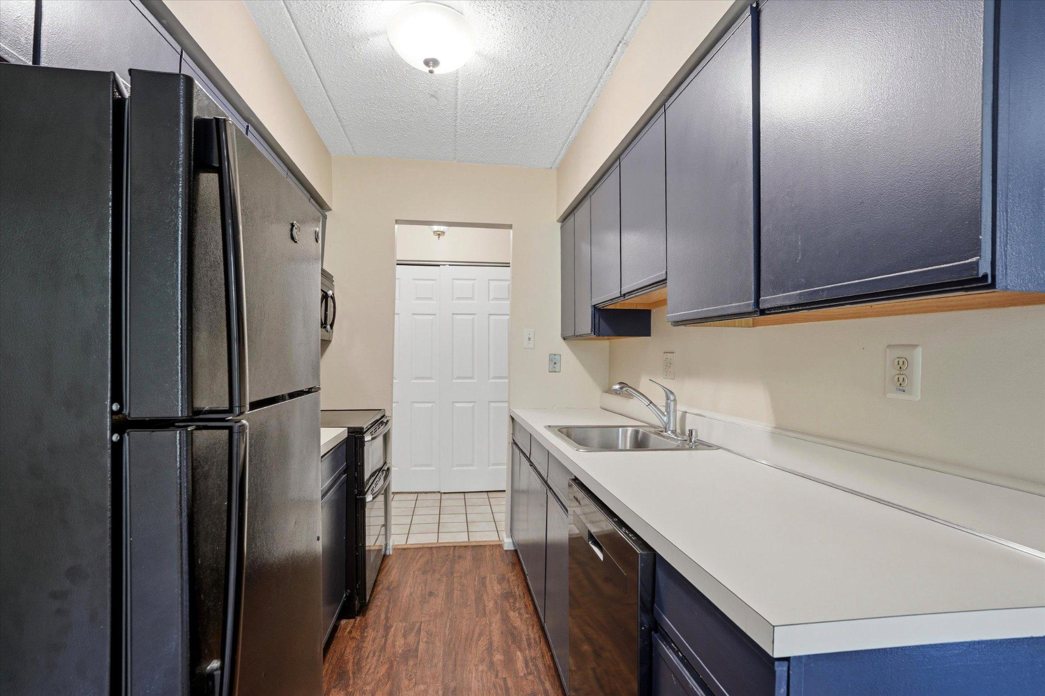 623 Washington Place Chesterbrook, PA 19087 - Photo 7 of 26 a kitchen with a sink a refrigerator and cabinets