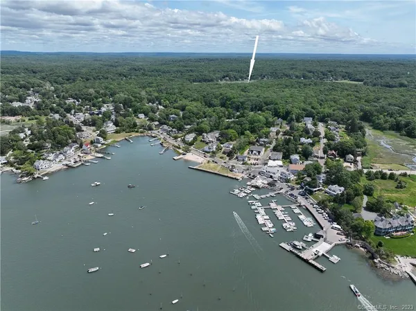 an aerial view of a house with a yard and lake view