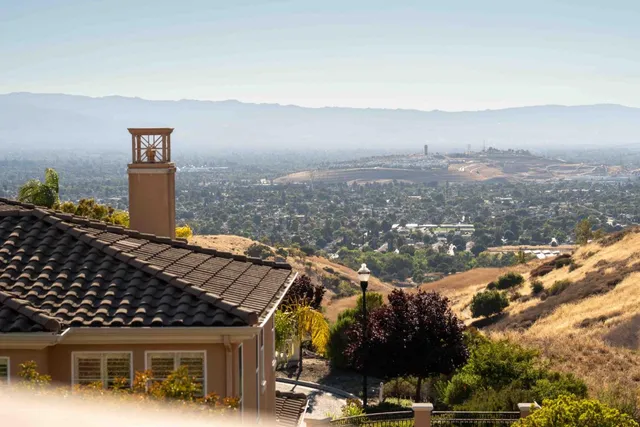 a view of a balcony with mountain view and wooden floor