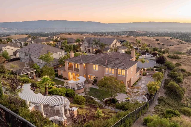 a spacious bedroom with a bed and a lamp