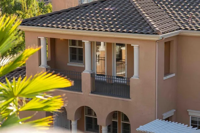 a spacious bedroom with a balcony a bed and a fireplace