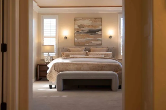 a dining room with furniture a potted plant and wooden floor