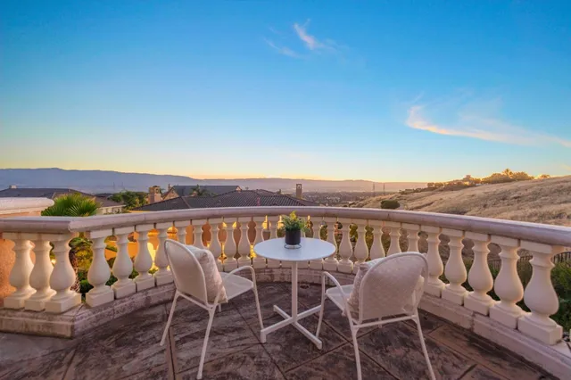 a view of a chairs and table in the patio