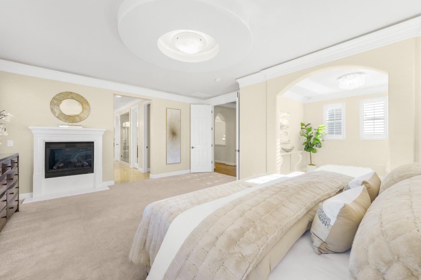 4800 Shady Meadows Place San Jose, CA 95138 - Photo 53 of 89 a spacious bedroom with a balcony a bed and a fireplace