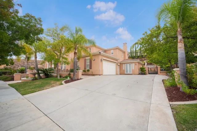 an aerial view of a house with a swimming pool outdoor seating and yard