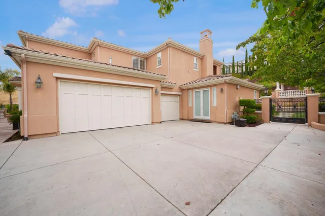 an aerial view of a house with a yard and lake view