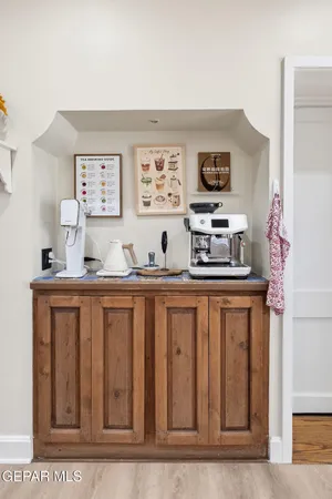 a view of a bedroom with a bed and wooden floor