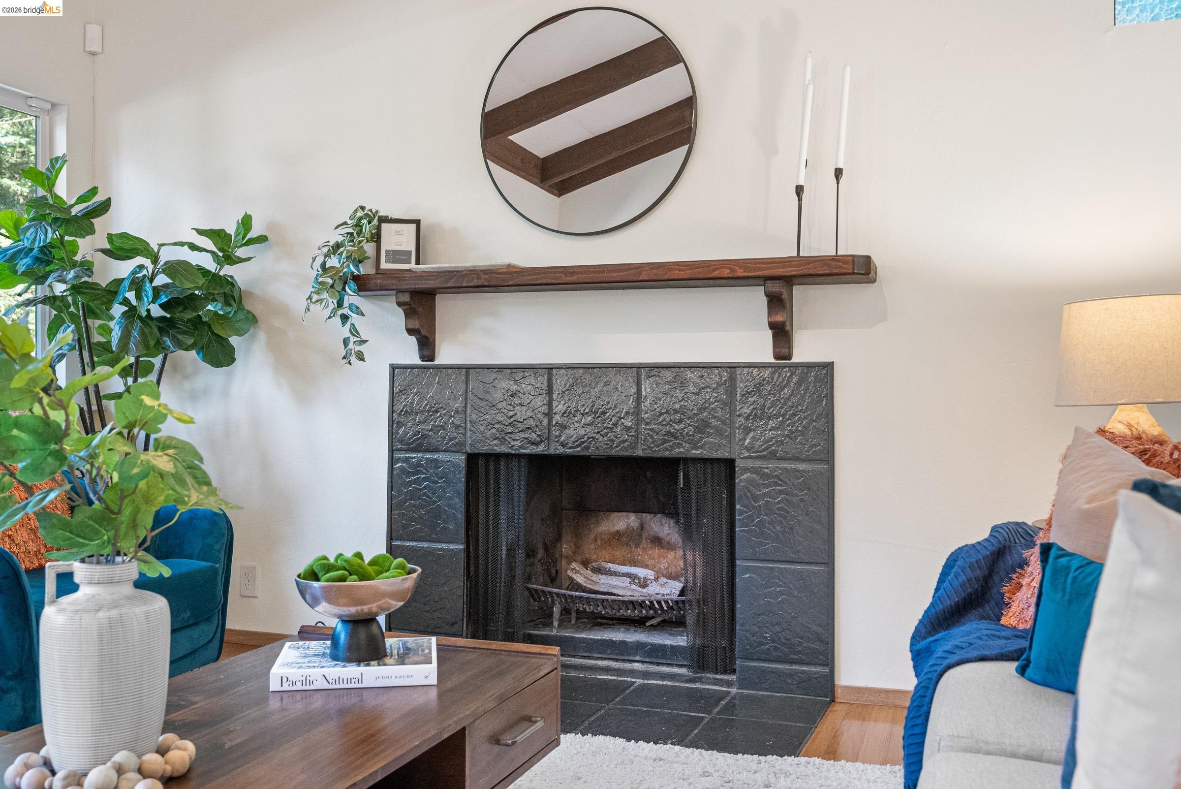 6600 Heather Ridge Way Oakland, CA 94611 - Photo 10 of 66 Fireplace featuring dark tile surround, a built-in firebox with grate, and a substantial wood mantel