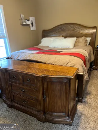 a bedroom with a bed and a mirror