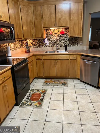 a kitchen with a sink a stove and a microwave