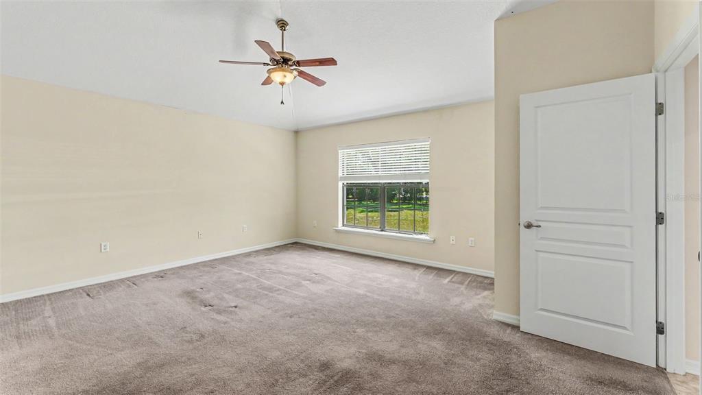 8525 North Campbell Road Lakeland, FL 33810 - Photo 22 of 45 an empty room with a ceiling fan and window