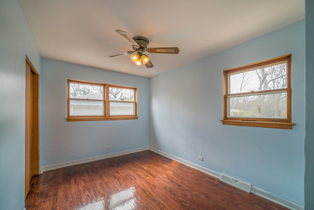 7609 Traube Street North Riverside, IL 60546 - Photo 13 of 25 a view of an empty room with a window and wooden floor
