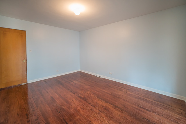 7609 Traube Street North Riverside, IL 60546 - Photo 16 of 25 a view of an empty room with wooden floor and a window