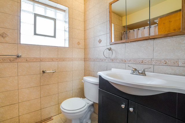 7609 Traube Street North Riverside, IL 60546 - Photo 17 of 25 a bathroom with a sink a toilet and a mirror