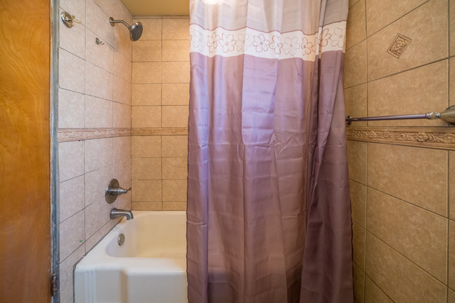 7609 Traube Street North Riverside, IL 60546 - Photo 18 of 25 a bathroom with a shower curtain and a sink