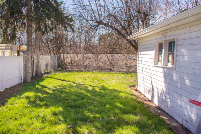 7609 Traube Street North Riverside, IL 60546 - Photo 23 of 25 a view of a backyard with a large tree