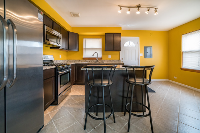 7609 Traube Street North Riverside, IL 60546 - Photo 5 of 25 a kitchen with stainless steel appliances a sink stove and refrigerator