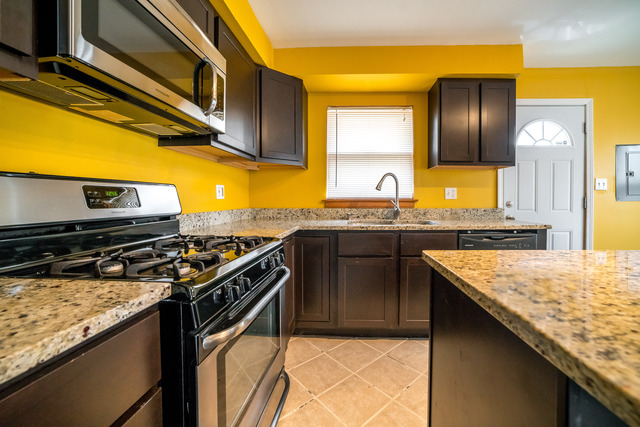 7609 Traube Street North Riverside, IL 60546 - Photo 7 of 25 a kitchen with a stove and a microwave