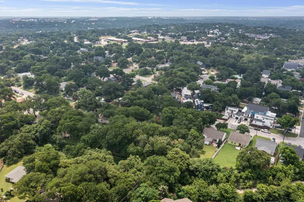 an aerial view of residential houses with city view