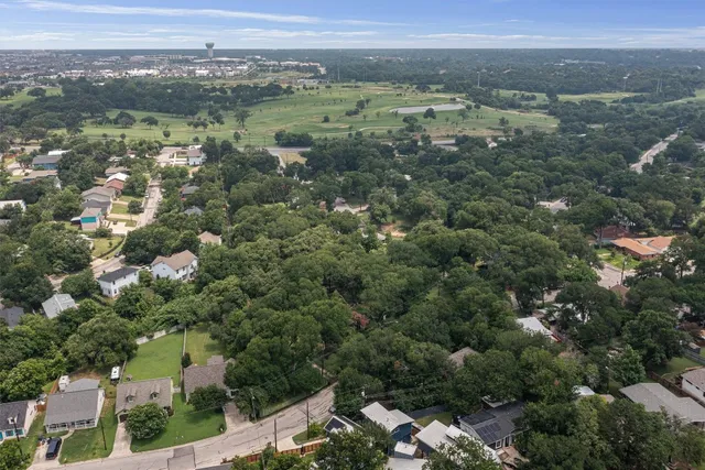 an aerial view of town with residential houses with outdoor space and trees