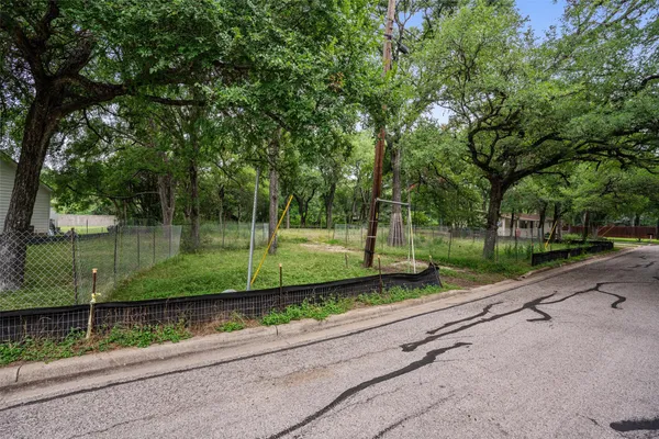 a view of a street with a yard
