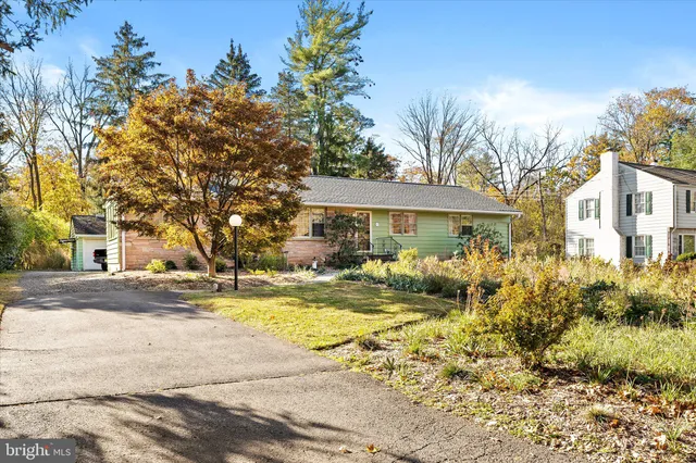 a view of a house with a tree in the background