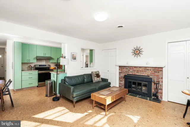 a living room with furniture and a fireplace