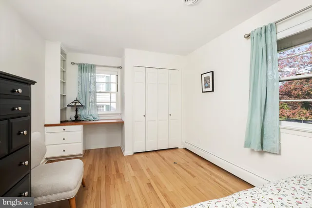 a room with a dresser and a window