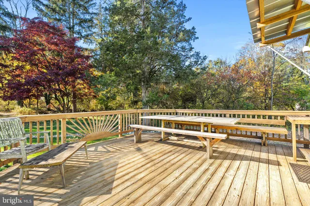 a view of balcony with wooden floor and fence