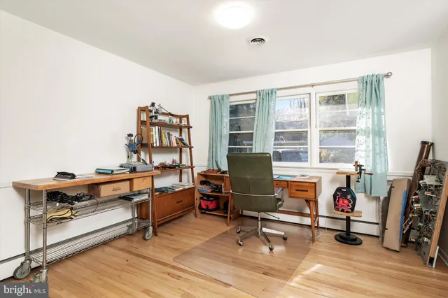 a view of a workspace with furniture and a window