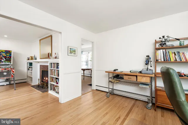 a view of a workspace with furniture and wooden floor