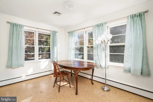 a dining room with wooden floor and a table