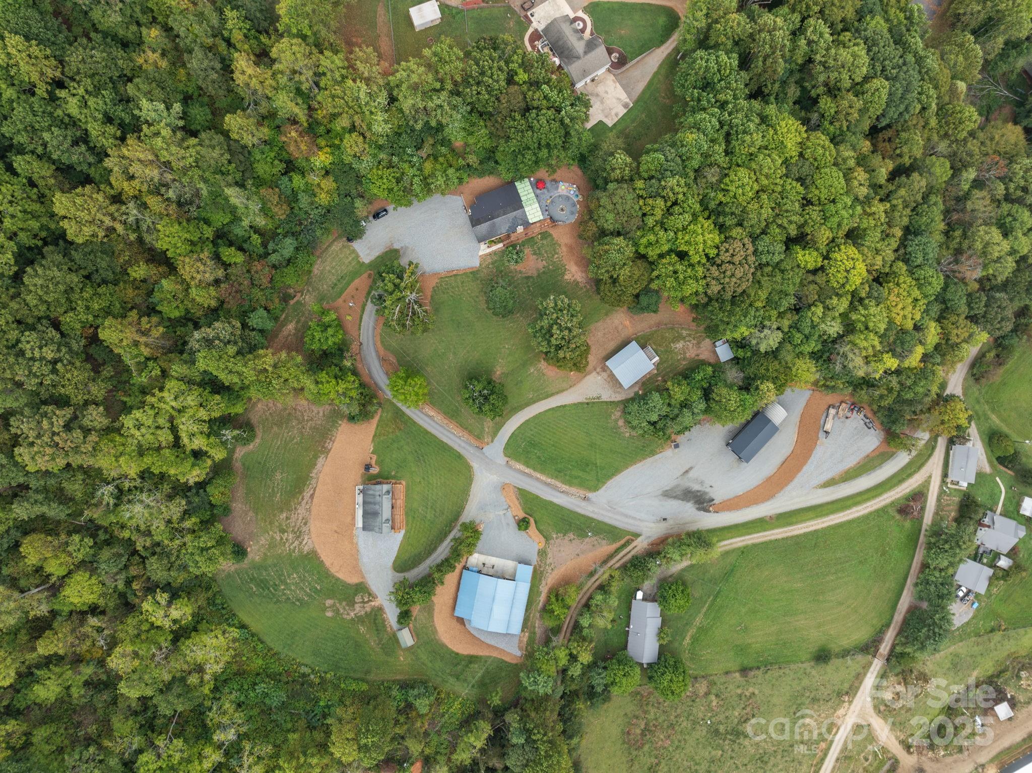 263 Morgan Branch Road Leicester, NC 28748 - Photo 12 of 31 an aerial view of a house with a yard and large trees