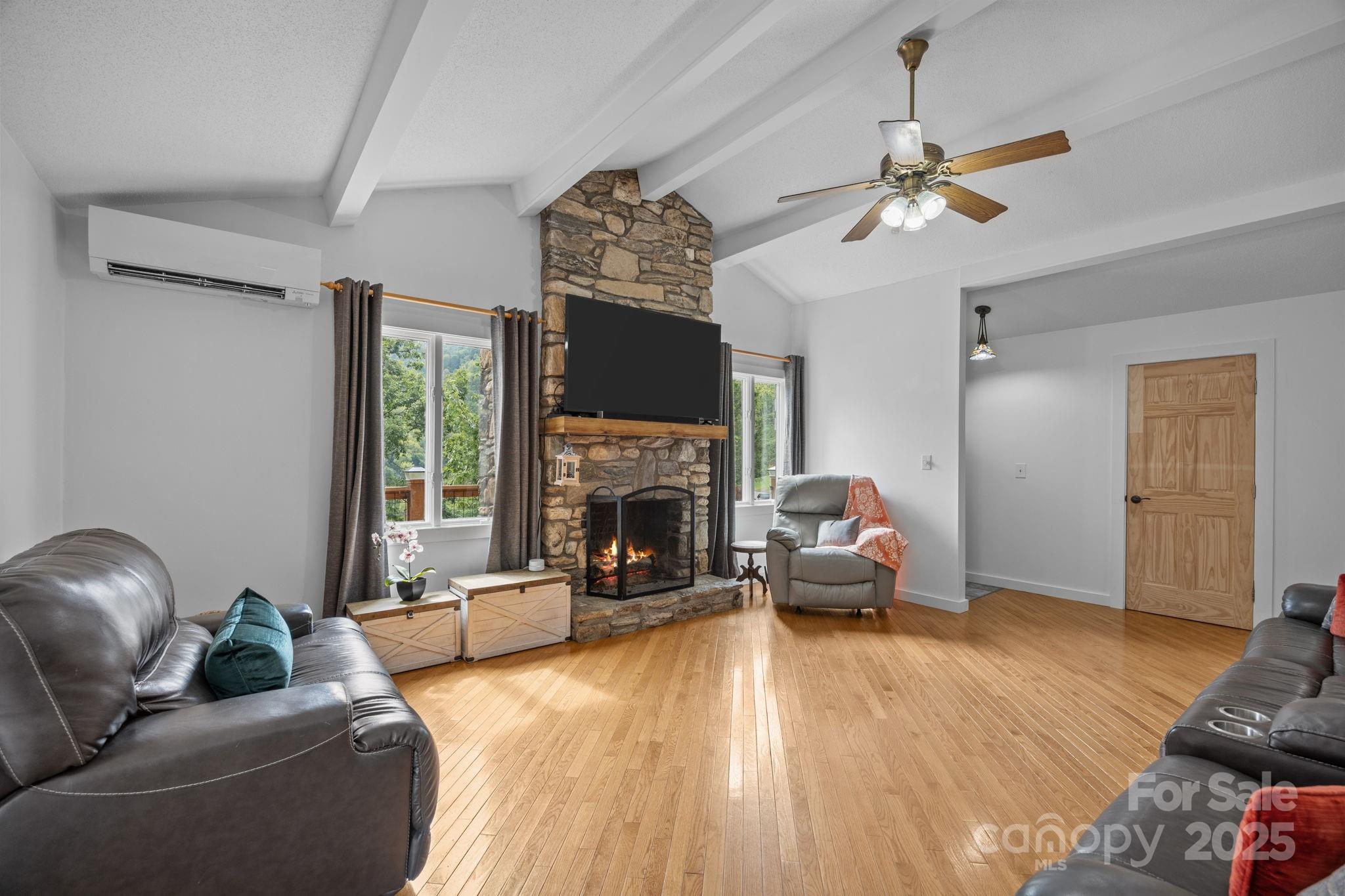 263 Morgan Branch Road Leicester, NC 28748 - Photo 15 of 31 a living room with furniture a fireplace and a flat screen tv