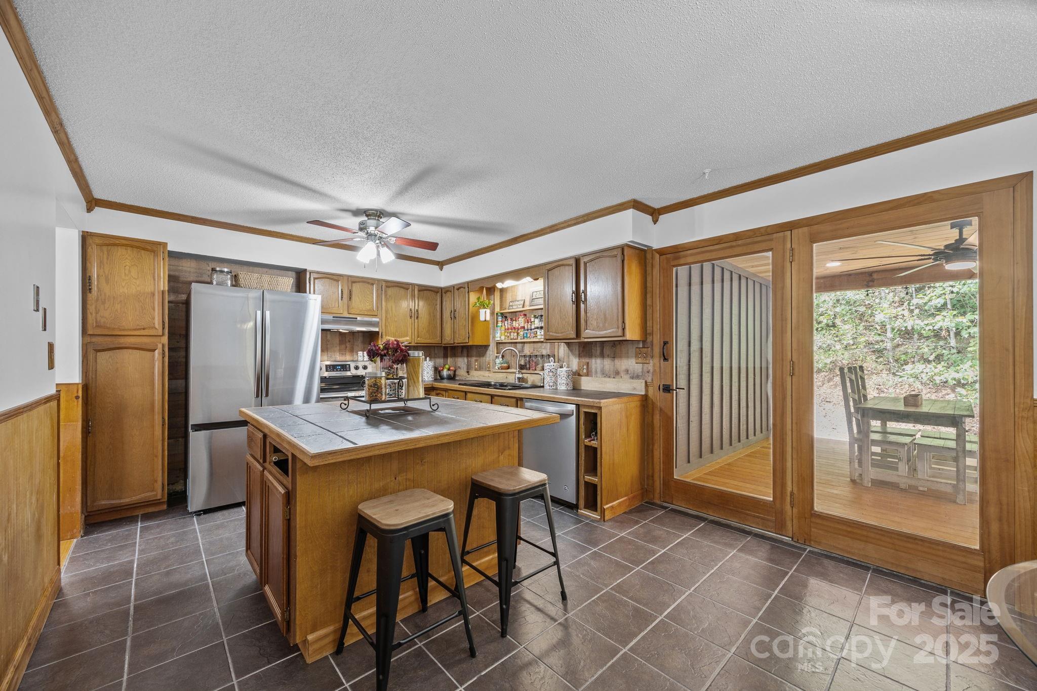 263 Morgan Branch Road Leicester, NC 28748 - Photo 18 of 31 a kitchen with kitchen island a large counter top space and stainless steel appliances