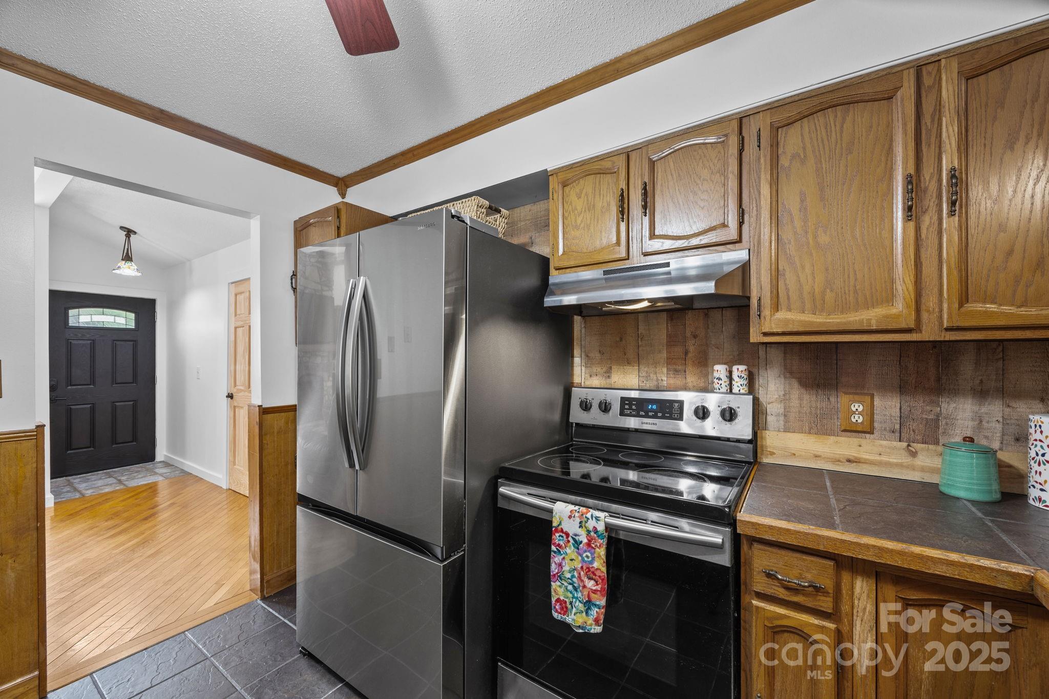 263 Morgan Branch Road Leicester, NC 28748 - Photo 19 of 31 a kitchen with stainless steel appliances granite countertop a refrigerator a stove and a sink