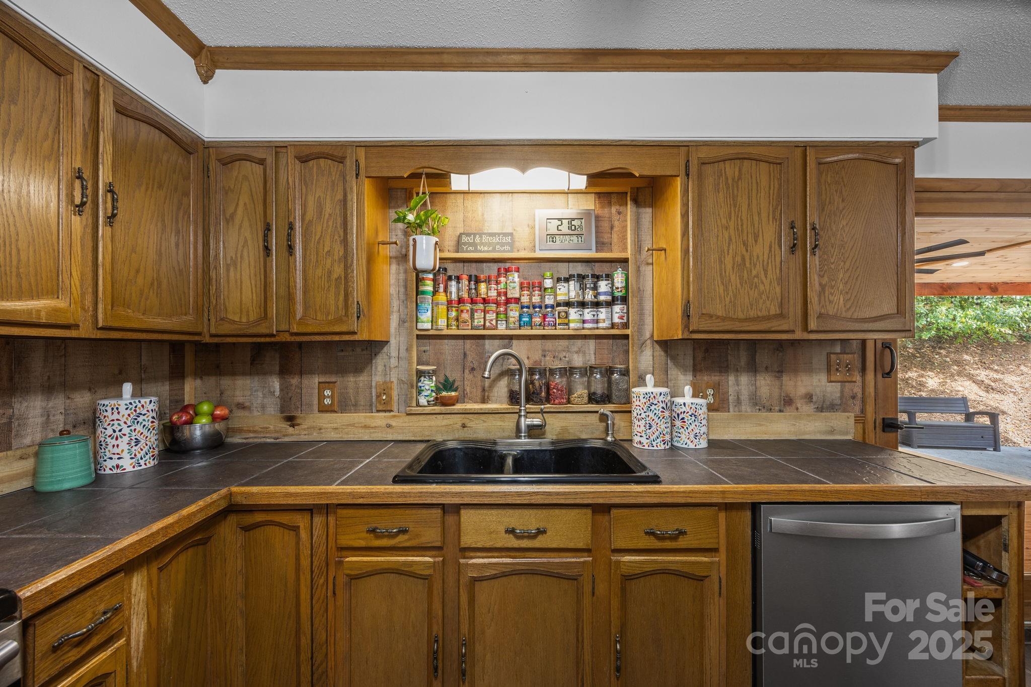 263 Morgan Branch Road Leicester, NC 28748 - Photo 20 of 31 a kitchen with stainless steel appliances granite countertop a sink a stove cabinets and a window