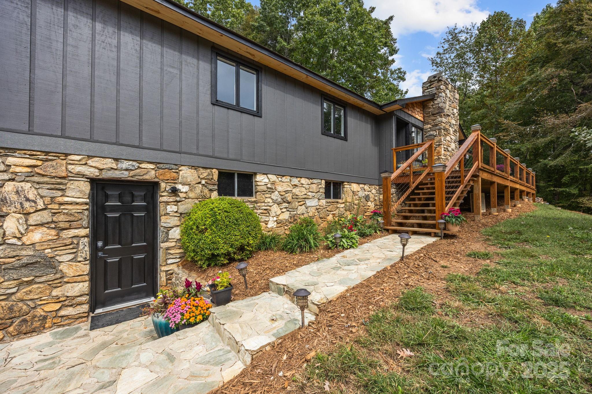 263 Morgan Branch Road Leicester, NC 28748 - Photo 2 of 31 a view of a wooden house with a yard and potted plants