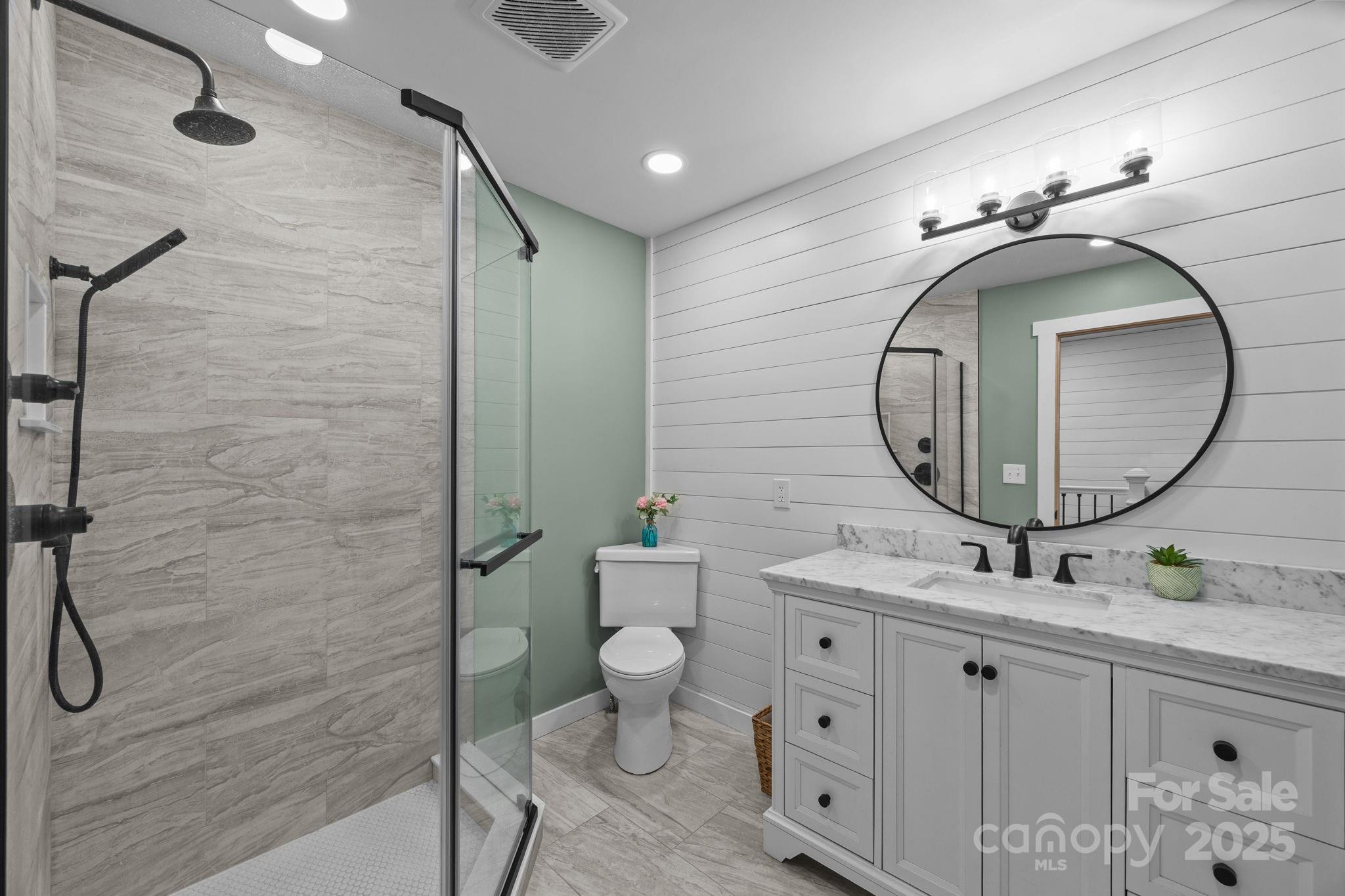 263 Morgan Branch Road Leicester, NC 28748 - Photo 28 of 31 a bathroom with a sink mirror and toilet