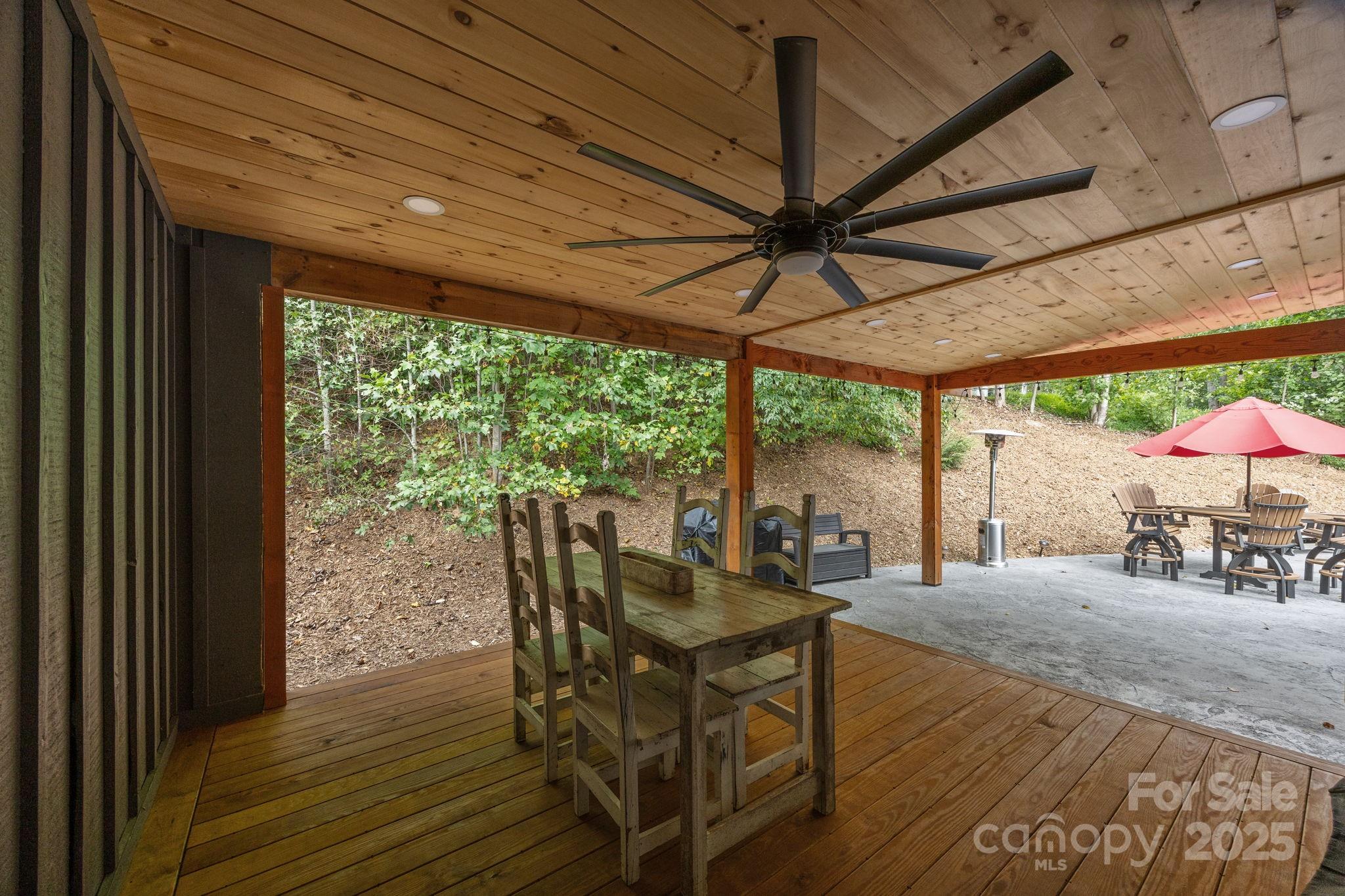 263 Morgan Branch Road Leicester, NC 28748 - Photo 8 of 31 a view of a patio with table and chairs under an umbrella