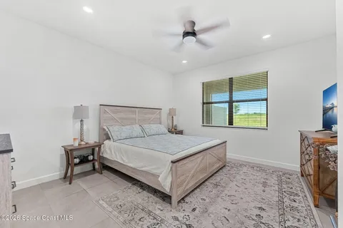 a bedroom with a bed and closet with mirror